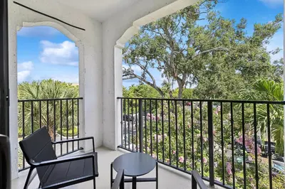 a porch with a chair and a table at Kasa Hollywood Fort Lauderdale in Dania Beach