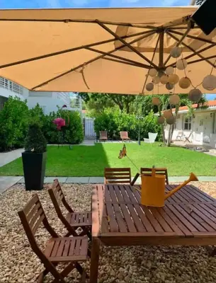a wooden table and chairs under an umbrella at B03 Location! Studio close 2 Beach & Design District in Miami