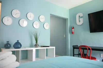 a room with clocks on the wall and a bed at B03 Location! Studio close 2 Beach & Design District in Miami