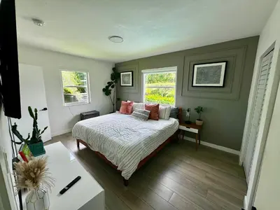a bedroom with a bed and two windows at Pura Vida Villa in Miami