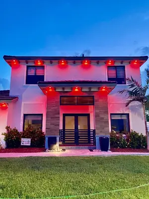 a white house with red lights on it at Tropical Studio in Miami