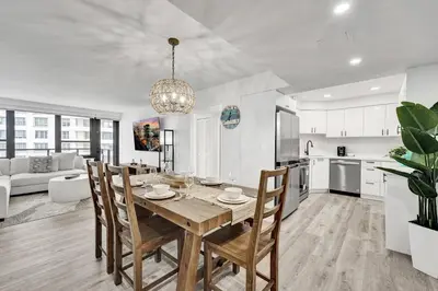 a kitchen and dining room with a table and chairs at Cozy Oceanfront Beach Service 917 in Miami Beach