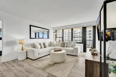 a living room with a white couch and a table at Cozy Oceanfront Beach Service 917 in Miami Beach