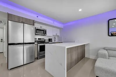 a kitchen with white cabinets and a white counter top at Amazing 3 bedrooms 3 bathrooms Beach Resort 1518 in Miami Beach