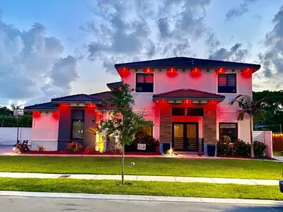 a white house with red lights on it at Tropical Studio in Miami