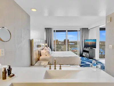 a white bathroom with a bed and a sink at FLL W Residence Penthouse, AMAZING birds eye views! in Fort Lauderdale