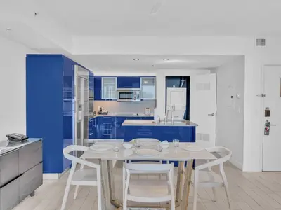 a blue and white kitchen with a table and chairs at FLL W Residence Penthouse, AMAZING birds eye views! in Fort Lauderdale