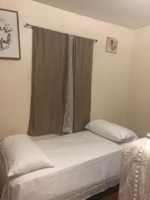 a bed in a room with a window with avertisement at Josiane Peace of stay in Miami