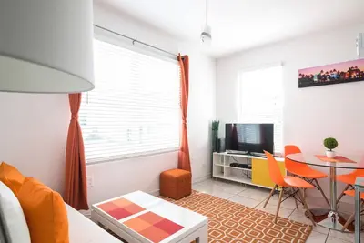 a living room with a table and a dining room at 1Bedroom Collins 2 Blocks to Ocean with Paid Street Parking in Miami Beach