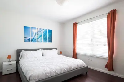 a bedroom with a large bed and a window at 1Bedroom Collins 2 Blocks to Ocean with Paid Street Parking in Miami Beach