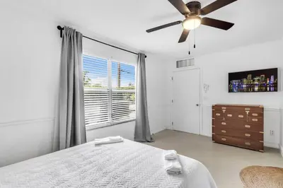 a bedroom with a bed and a ceiling fan at Spacious 5 Bedroom Heated Pool and Hot Tub, 12 minutes to the Beach in Hollywood