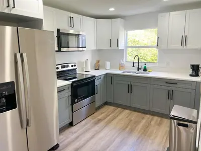 a kitchen with white cabinets and stainless steel appliances at New 3Bedroom 2Bathroom Private Home in Miami