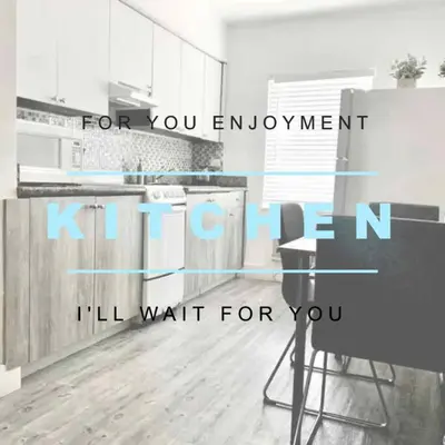 a kitchen with white cabinets and a table in it at B04 7 minutes from the beach Midtown Miami in Miami
