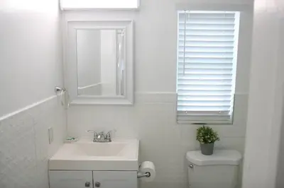 a bathroom with a sink and a toilet and a window at B05 Nicest 1 bedroom APT in Midtown Miami in Miami