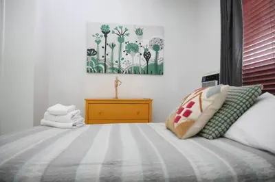 a bedroom with a bed and a painting on the wall at B05 Nicest 1 bedroom APT in Midtown Miami in Miami