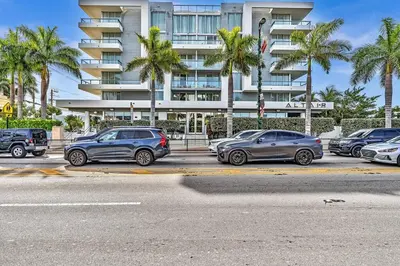 a parking lot with cars parked in front of a building at King Suite balcony water views-Hosted by Sweetstay in Miami Beach