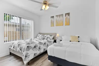 a bedroom with two beds and a ceiling fan at Beautiful Apt 5min walking Design District apt 1 in Miami