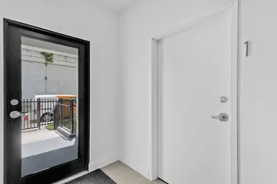a mirror in a room next to a door at Beautiful Apt 5min walking Design District apt 1 in Miami