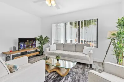 a living room with a couch and a table at Beautiful Apt 5min walking Design District apt 1 in Miami