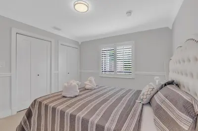 a bedroom with a bed with two stuffed animals on it at Tropical Oasis with Heated Pool and BBQ in Tamiami