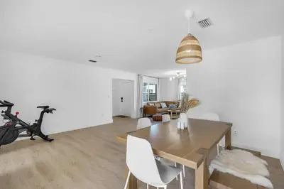 a dining room with a table and a exercise bike at Modern 3 Bedroom GetAway with Parking in Coral Gables in Miami