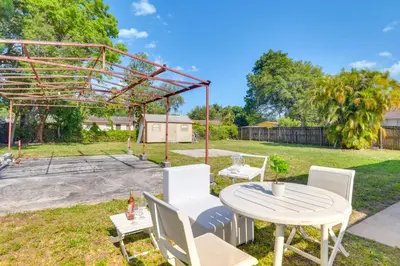 a patio with a table and chairs in a yard at Miami Gardens Apt 5 Miles to Hard Rock Stadium in Miami Gardens