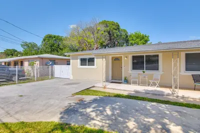 a small yellow house with a driveway at Miami Gardens Apt 5 Miles to Hard Rock Stadium in Miami Gardens