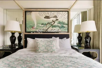 a bedroom with a bed with two lamps and a painting at Luxurious Stunning Views condo in Miami