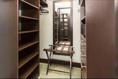 a walk in closet with a stool and a mirror at Luxurious Stunning Views condo in Miami