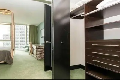 a room with a black cabinet and a bedroom at Luxurious Stunning Views condo in Miami