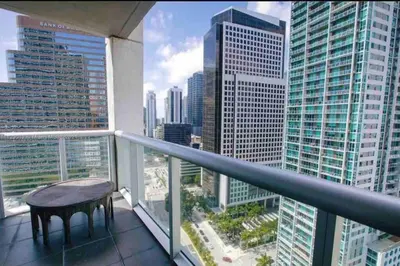 a balcony with a table and a view of a city at Luxurious Stunning Views condo in Miami