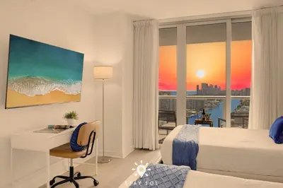 a hotel room with a bed and a desk and a window at Beautiful Studio Amazing View Balcony in Hallandale Beach
