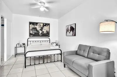 a living room with a bed and a couch at Downtown Hollywood Beach Blvd Studio Getaway in Hollywood