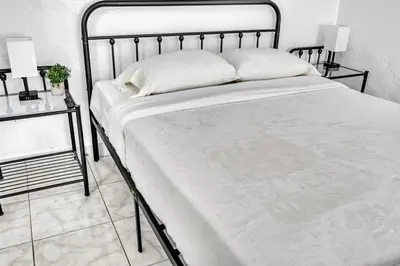 a large bed with a metal frame in a bedroom at Downtown Hollywood Beach Blvd Studio Getaway in Hollywood