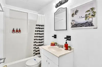 a white bathroom with a sink and a toilet at Downtown Hollywood Beach Blvd Studio Getaway in Hollywood