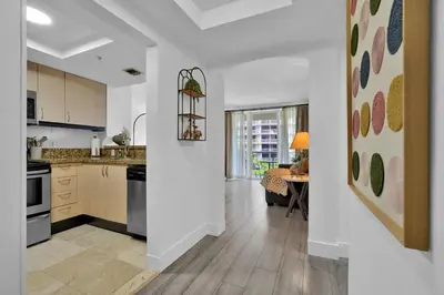 a kitchen with white walls and a dining room at Serene Cozy Retreat with Balcony Free Parking in Miami
