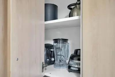 a cupboard with a blender and other items on it at Serene Cozy Retreat with Balcony Free Parking in Miami
