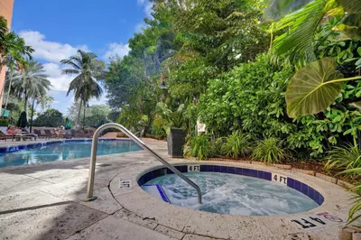 a swimming pool with a hot tub in a resort at Serene Cozy Retreat with Balcony Free Parking in Miami