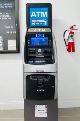 an atm machine sitting next to a wall at Magical bright Apt 5min walking Design District apt 5 in Miami