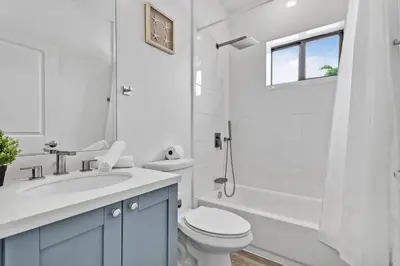 a bathroom with a toilet and a sink and a shower at Magical bright Apt 5min walking Design District apt 5 in Miami