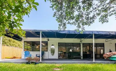 a house with a blue roof at Charming 2BR Waterfront House in Fort Lauderdale