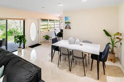 a living room with a white table and chairs at Charming 2BR Waterfront House in Fort Lauderdale