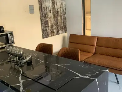 a dining room with a glass table and a couch at Ocean View Habana in Hialeah