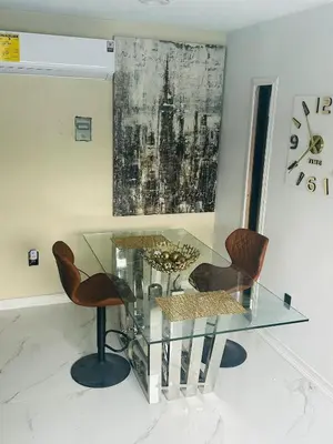 a glass table and chairs in a room at Ocean View Habana in Hialeah
