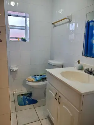 a white bathroom with a toilet and a sink at Coco Sol 2 by MyMiamiStay in Miami