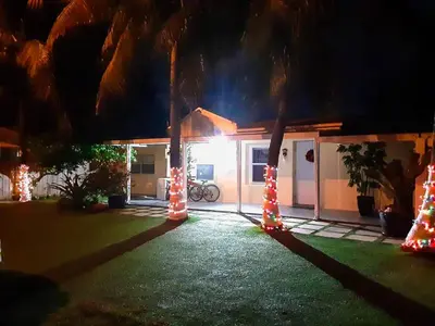 a house with christmas lights in a yard at night at Coco Sol 2 by MyMiamiStay in Miami