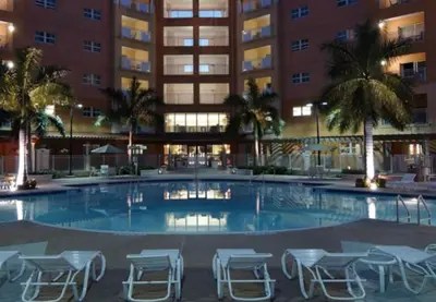 a large swimming pool with chairs and a building at Marriott Villas at Doral 2BD sleeps 8 in Miami