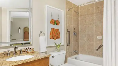 a bathroom with a toilet and a sink and a tub at Marriott Villas at Doral 2BD sleeps 8 in Miami