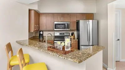 a kitchen with a counter and a refrigerator at Marriott Villas at Doral 2BD sleeps 8 in Miami