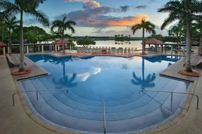 a large pool at a resort with palm trees at Marriott Villas at Doral 2BD sleeps 8 in Miami